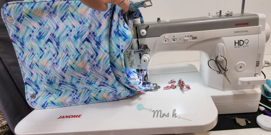 A bag being topstitched on a Janome HD9 sewing machine with extension table