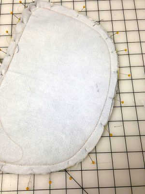 Basting stitches on the back of a bag panel
