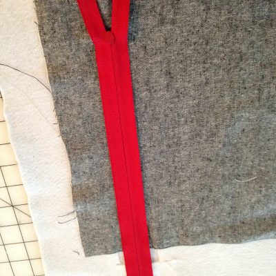 Red zipper face down on a zipper pocket (Vertical Zipper Pocket Tutorial from Swoon Patterns)